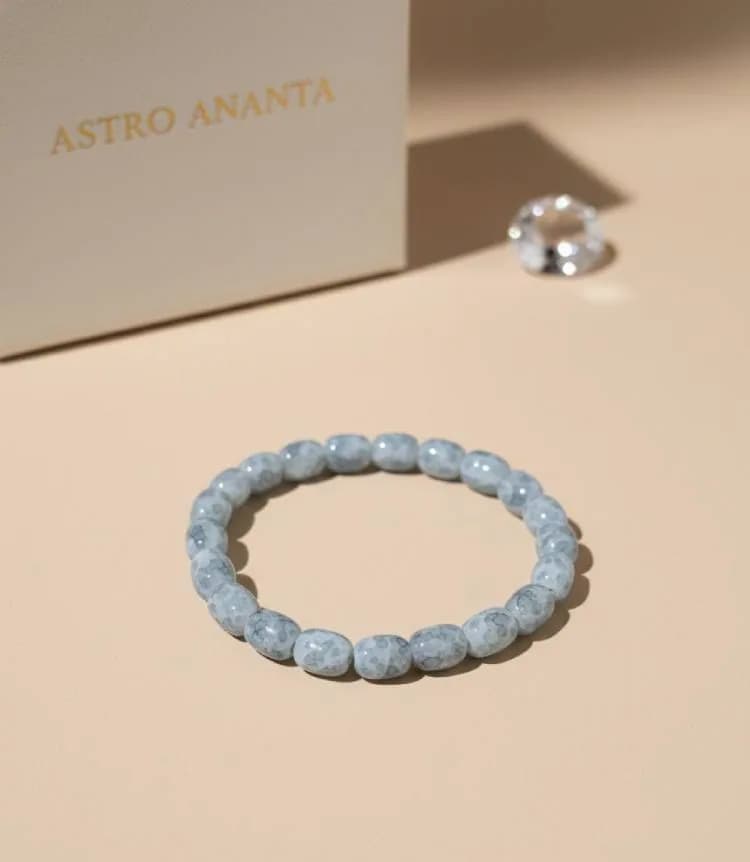 Blue Cracked Agate Stone Bracelet with a clear diamond-cut quartz on a beige background.